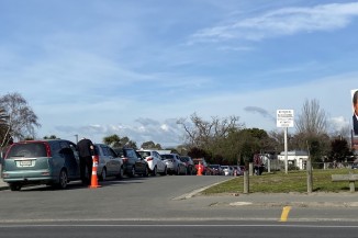 Line of cars at Covid-19 test site on Pages Road