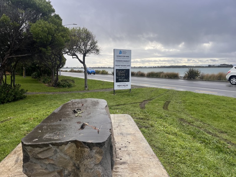 Tire marks in grass around stolen statue remains