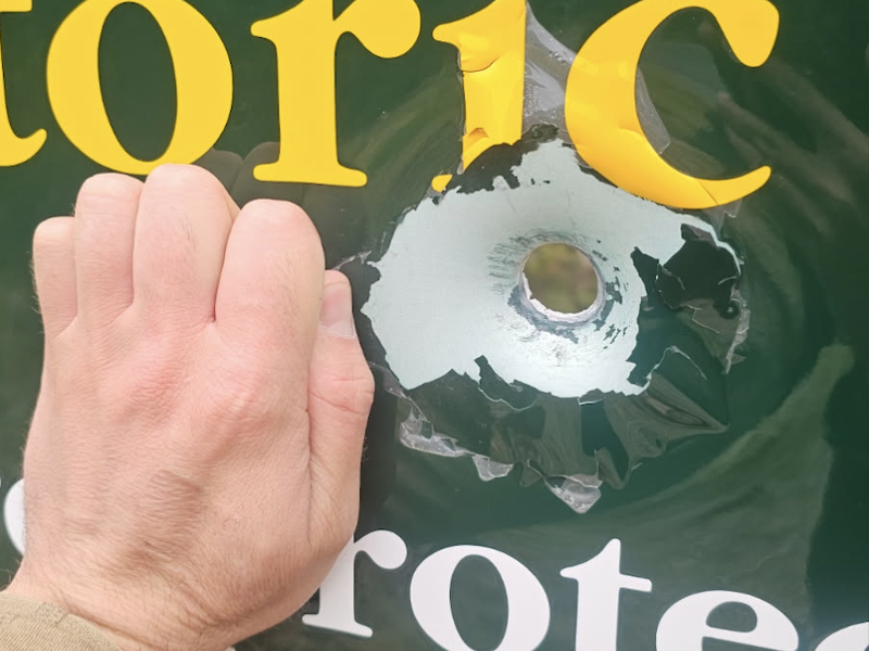 bullet hole in sign
